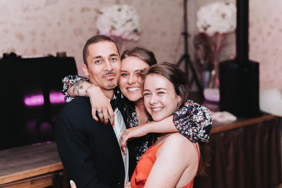 Trois amis posent ensemble en soirée